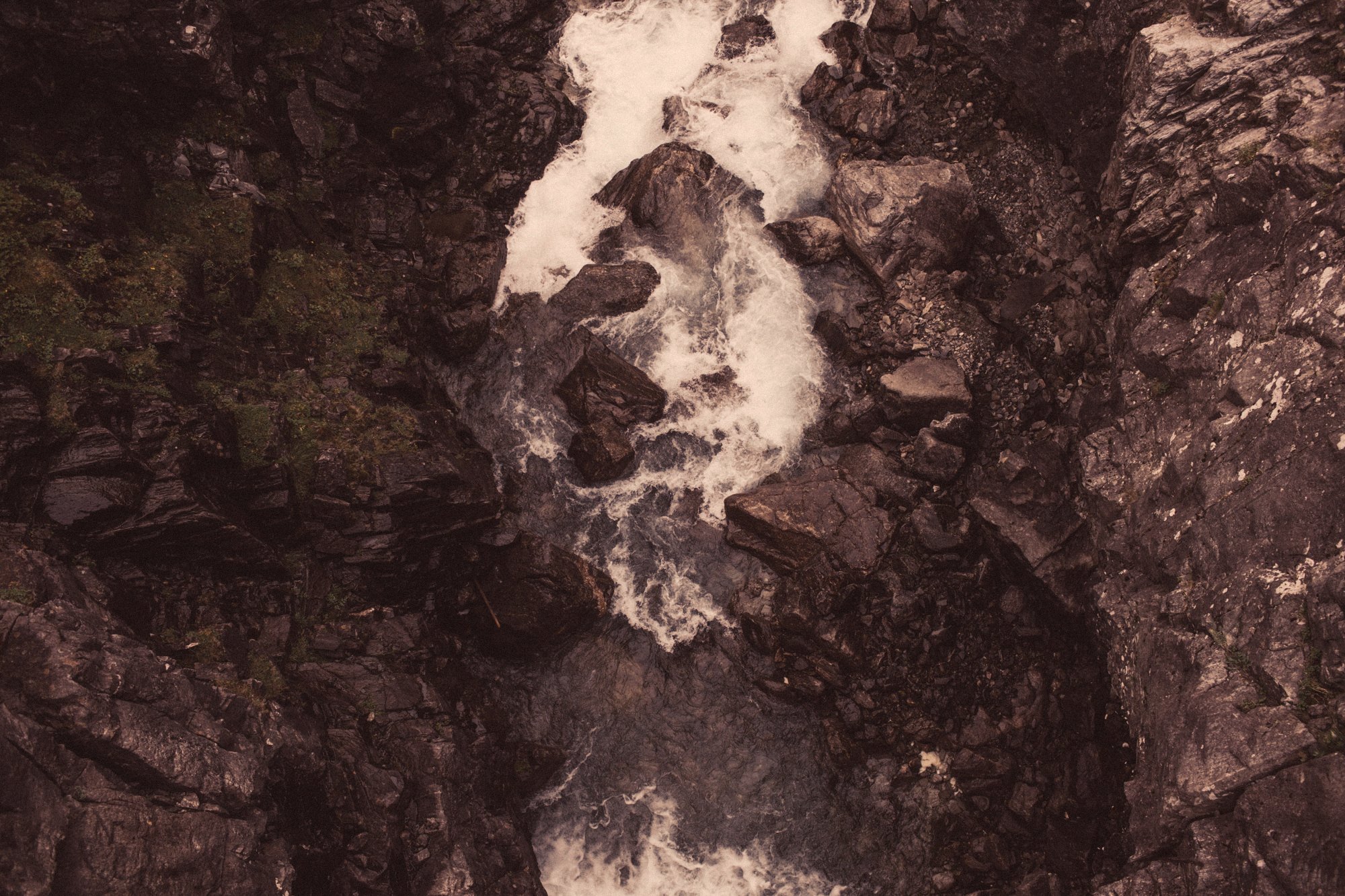 Water rushing over dark rocks